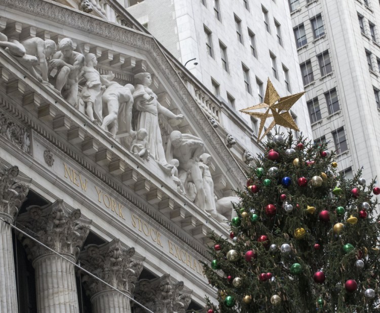 A golden star tops the Christmas tree outside the New York Stock Exchange on Wall Street on Thursday.