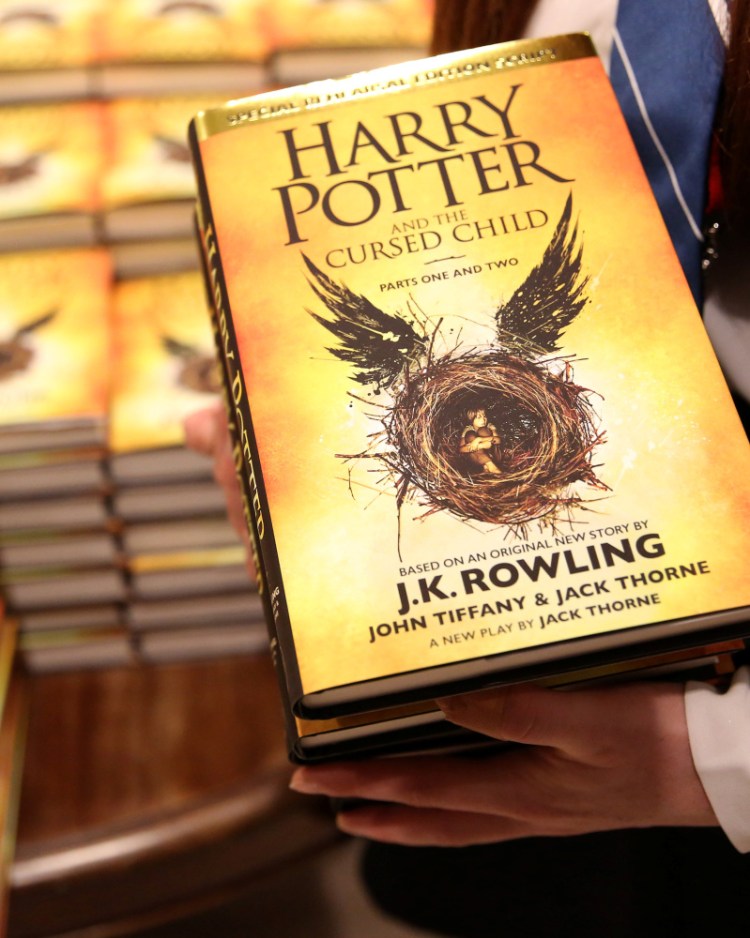 A store assistant holds copies of the book "Harry Potter and the Cursed Child" at a store in London in 2016.