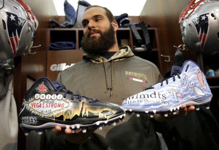 Patriots defensive end Lawrence Guy displays cleats that honor victims of the Oct. 1 Las Vegas shooting, left, and families who have lost an infant, right. Guy will honor both causes during the NFL's My Cause, My Cleats initiative.