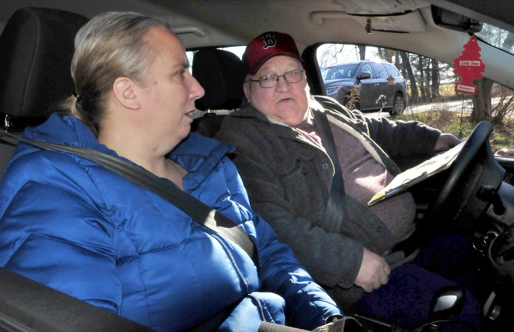 Kennebec Valley Community Action Program volunteer driver John Bryant chats with client Jewel York while driving her to work Thursday in Waterville.