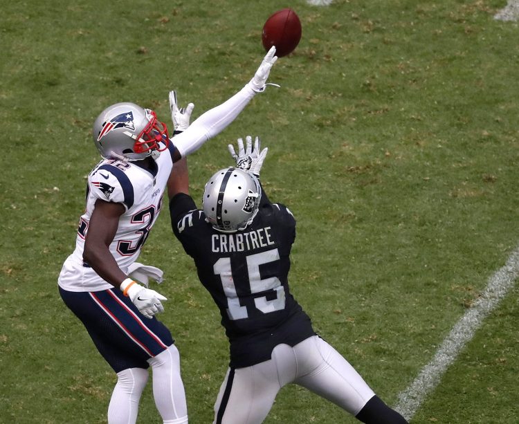 Patriots safety Devin McCourty breaks up a pass intended for Oakland receiver Michael Crabtree during New England's 33-8 win Sunday in Mexico City. After a rough start this season, the Patriots' defense has been holding opponents' scores down and creating opportunities for the offense.