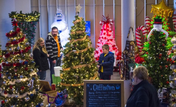 People browse among the many Christmas trees on display Friday at the Sukeforth Family Festival of Trees at the Hathaway Creative Center in Waterville.