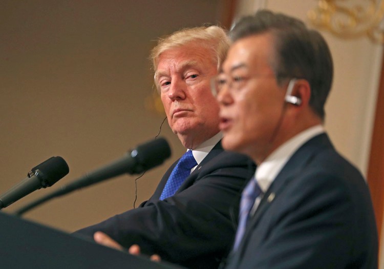 President Trump listens to South Korean President Moon Jae-in during a joint news conference in Seoul, South Korea, Tuesday.
