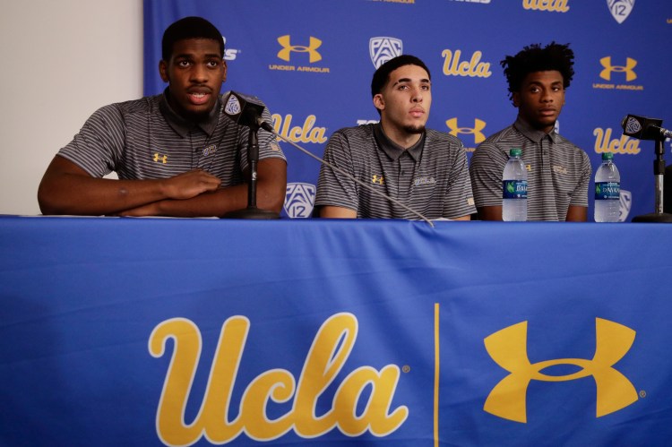 UCLA basketball player Cody Riley, left, reads his statement as he is joined by teammates LiAngelo Ball, center, and Jalen Hill during a news conference at UCLA Wednesday in Los Angeles. Three UCLA NCAA college basketball players accused of shoplifting in China admitted to the crime and apologized before Coach Steve Alford announced they were being suspended indefinitely. 