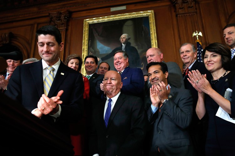House Speaker Paul Ryan of Wisconsin, left, leads applause for House Ways and Means Chair Rep. Kevin Brady, R-Texas, along with Rep. Carlos Curbelo, R-Fla., and Rep. Cathy McMorris Rodgers, R-Wash., during a news conference following a vote on tax reform on Capitol Hill in Washington on Thursday. Republicans passed a nearly $1.5 trillion package overhauling corporate and personal taxes through the House.