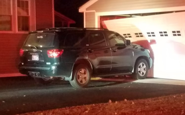 Police say Nelson Brown crashed into this SUV hard enough to push it into the garage and knock the garage off its foundation.