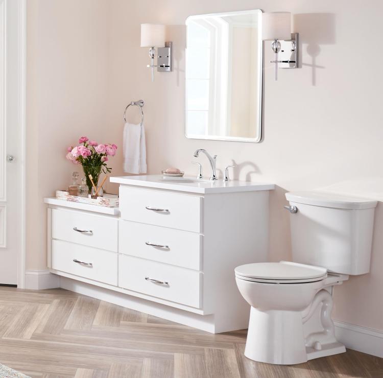 Upgraded sconce lighting, a high-efficiency toilet, and stylish bath faucets from the American Standard Patience collection are key factors in attracting potential home-buyers.