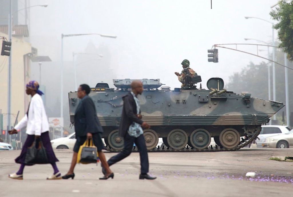 A Zimbabwe army tank blocks an intersection  in Harare, Wednesday. In the wake of a military takeover in Zimbabwe, the national police force has recalled all officers on leave. 