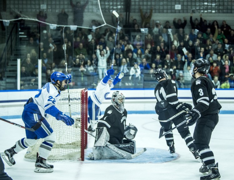 Colby players celebrate a first-period goal by Kienan Scott during their 4-2 win over Bowdoin.