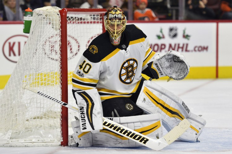 Boston Bruins goalie Tuukka Rask looks for a loose puck while guarding the post during the second period of Saturday's game against Flyers in Philadelphia.