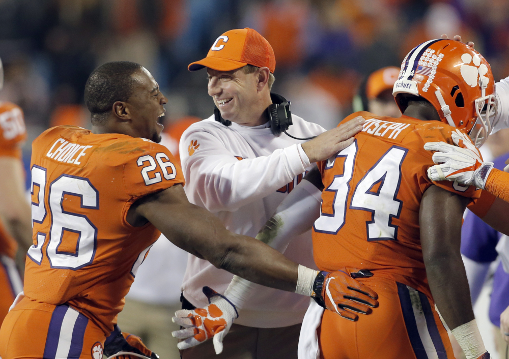Clemson Coach Dabo Swinney congratulates his players during their 38-3 win over Miami in the Atlantic Coast Conference championship game Saturday night in Charlotte, N.C.