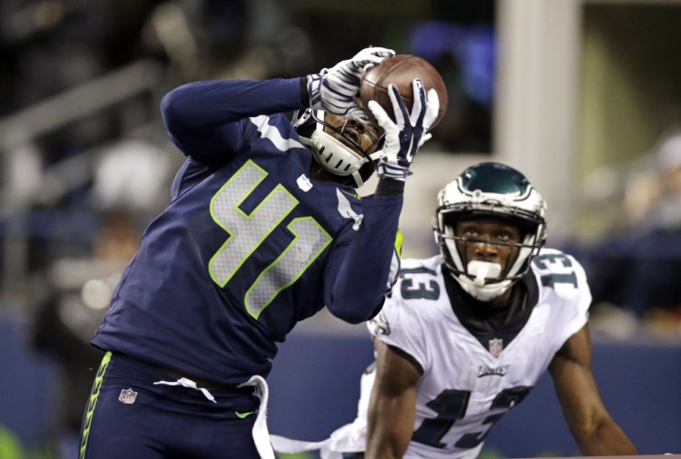 Seattle's Byron Maxwell intercepts a pass intended for Philadelphia's Nelson Agholor in the end zone during the second half Sunday night in Seattle.