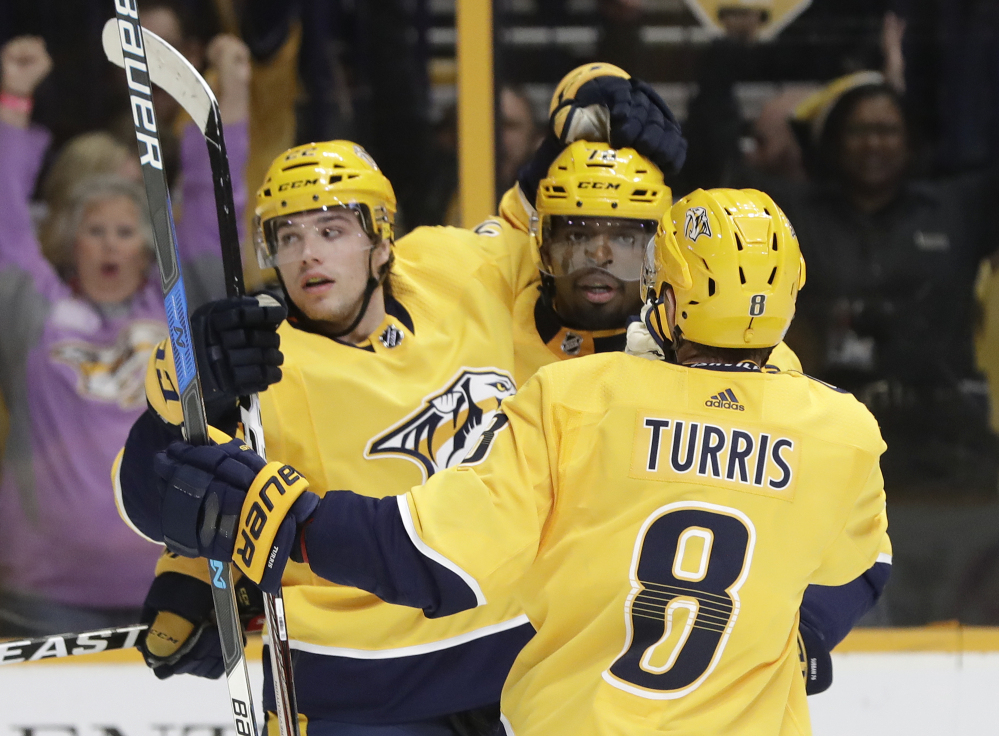 Nashville left wing Kevin Fiala (22) celebrates with P.K. Subban (76) and Kyle Turris after Fiala's goal in the second period. The Predators went on to win, 5-3.