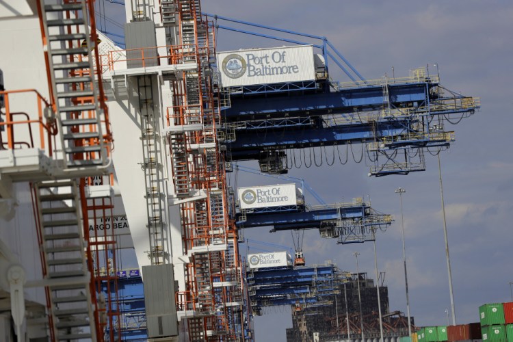 A line of cranes wait to unload ships at the Port of Baltimore. The Commerce Department reported that the U.S. trade deficit rose to $48.7 billion in October because of record imports.