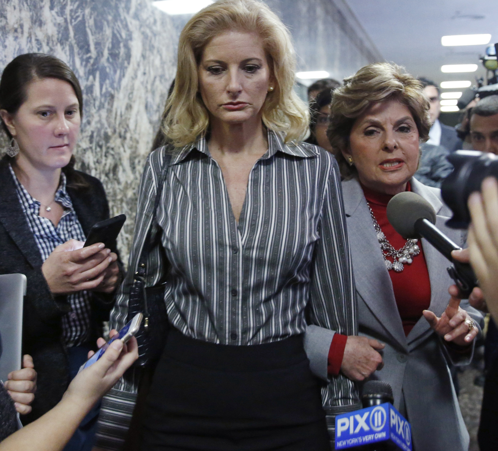 Gloria Allred, right, and her client Summer Zervos, center, push through the media as they leave Manhattan Supreme Court on Tuesday after a hearing in Zervos's defamation lawsuit against President Trump.