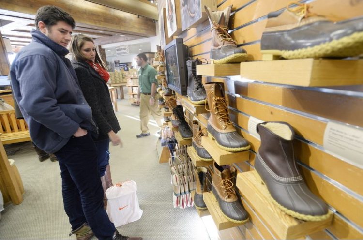 Patrons look at boots at the L.L. Bean store in Freeport. Sales of Bean boots have broken records.