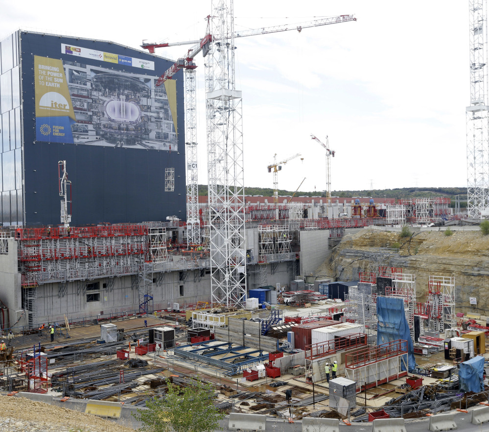 Cranes stand at the construction site of the International Thermonuclear Experimental Reactor in southern France. The design calls for a doughnut-shaped device called a tokamak that will trap superheated hydrogen to allow atoms to fuse together.