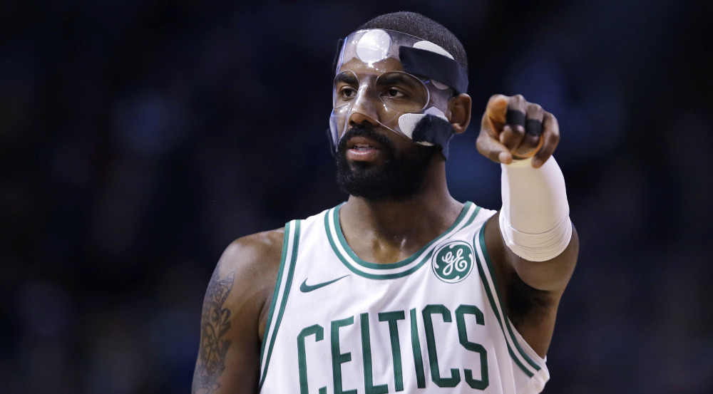 Boston guard Kyrie Irving directs a teammate during the first quarter of Wednesday night's game against Dallas in Boston. Irving scored 23 points as the Celtics beat the Mavs, 97-90.