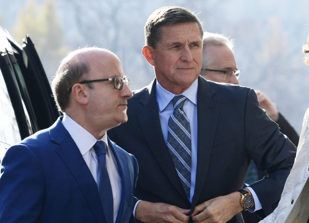 Former national security adviser Michael Flynn, right, is accused of texting a business associated about nuclear deals.