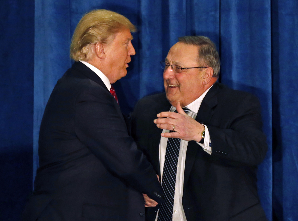 Gov. Paul LePage greets Donald Trump at a March 2016 campaign appearance in Portland. In letting a lawsuit against the president go forward, a federal judge cites LePage's stay at the Trump Organization's hotel when he was on official business with the federal government that included discussions with the president.