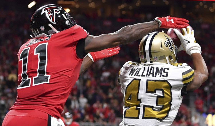 Saints free safety Marcus Williams picks off the ball against Atlanta Falcons wide receiver Julio Jones in the second half Thursday night in Atlanta.