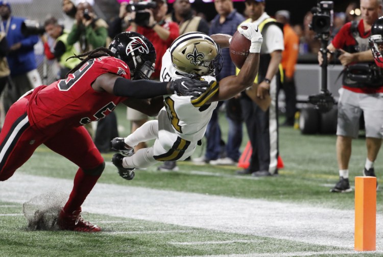 New Orleans wide receiver Tommylee Lewis dives into the end zone for a touchdown against Atlanta Falcons outside linebacker De'Vondre Campbell in the first half Thursday night in Atlanta.