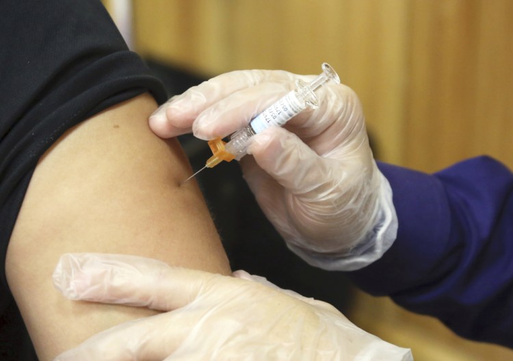 A flu vaccine injection is administered by a pharmacist in Brownsville, Texas. Health officials say the flu vaccine seems well matched to the viruses making people sick this year, but it's too early to tell how bad this season will be.