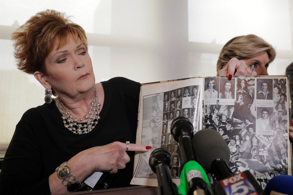 Beverly Young Nelson points to her high school yearbook last month after accusing Roy Moore of sexually assaulting her when she was 16. Moore had signed her yearbook, but she herself added some notes after his inscription, a fact that she clarified on Friday.