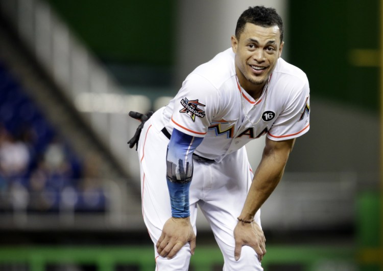 A person familiar with the negotiations says the New York Yankees and Miami Marlins are working on a trade that would send slugger Giancarlo Stanton to New York.