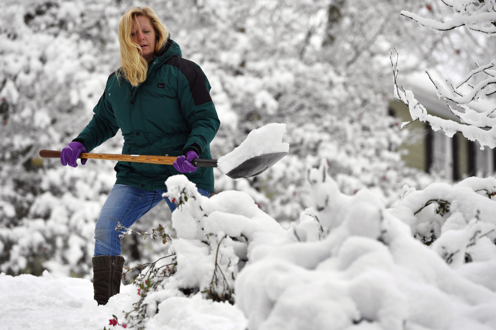 Laura Washington shovels her walk after a heavy snow Saturday in Kennesaw, Ga. The frigid temperatures behind a cold front combined with moisture off the Gulf of Mexico to bring unusual wintry weather to parts of the South.