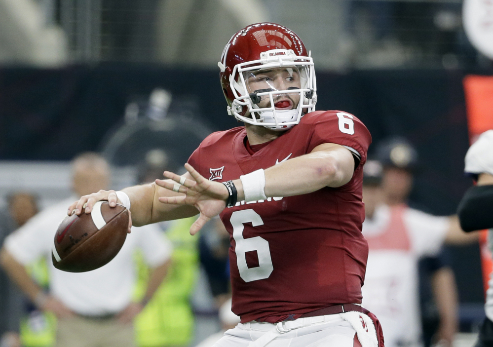In this Dec. 2, 2017, file photo, Oklahoma quarterback Baker Mayfield (6) throws a pass in the first half of the Big 12 Conference championship NCAA college football game against TCU  in Arlington, Texas. Mayfield, reigning Heisman winner Lamar Jackson of Louisville and Stanford running back Bryce Love were chosen as finalists for the Heisman Trophy on Monday, Dec. 4, 2017.
