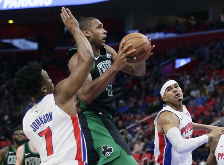 Boston forward Al Horford drives to the hoop against the Pistons' Stanley Johnson (7) and Tobias Harris on Sunday afternoon in Detroit. Horford had 18 points in Boston's 91-81 victory.