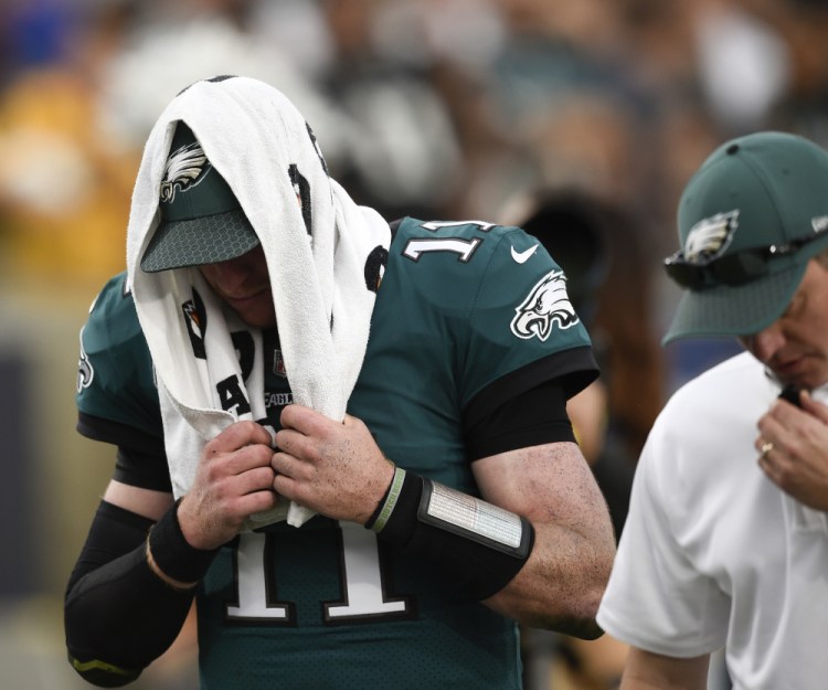 Eagles quarterback Carson Wentz leaves the field during the second half of Philadelphia's win against the Rams on Sunday in Los Angeles. Sources say Wentz has a torn left ACL.