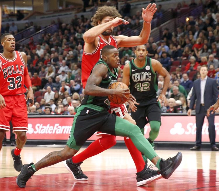 The Celtics' Terry Rozier drives past the Bulls' Robin Lopez in the first half of Monday night's game in Chicago.