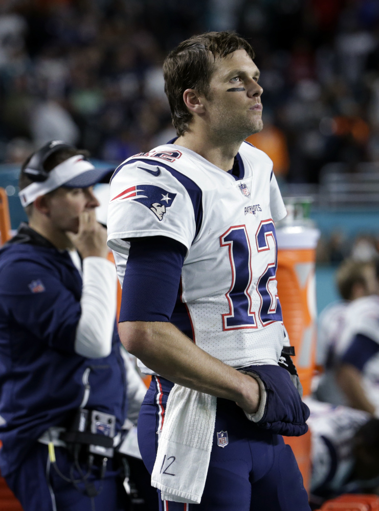 New England quarterback Tom Brady watches from the sidelines, during the second half against the Dolphins on Monday night in Miami Gardens, Fla. Miami won the game, 27-20, to snap the Patriots' 8-game win streak.