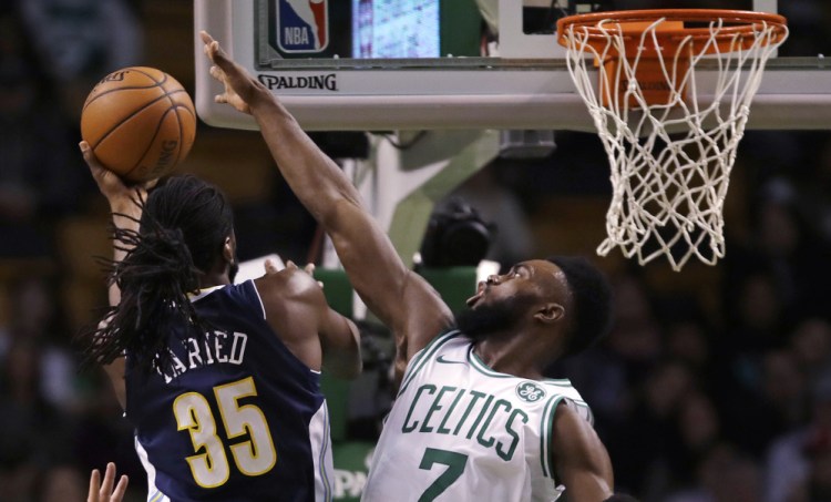 The Celtics' Jaylen Brown tries to block a shot by Denver forward Kenneth Faried in the first quarter of Wednesday night's game in Boston. Brown finished with 26 points and five rebounds.