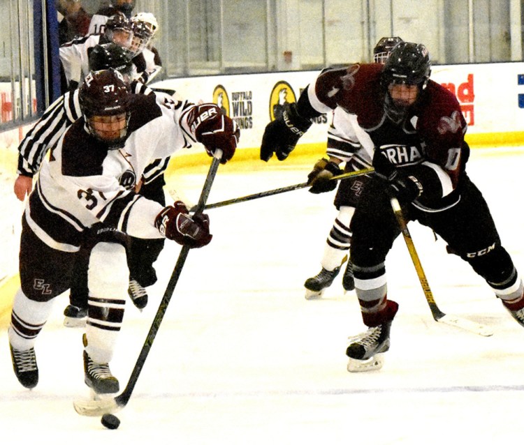 Colin Merritt of Edward Little brings the puck down the ice ahead of Jack Richards of Gorham during the Eddies' 4-1 victory Wednesday night in a boys' hockey game at the Norway Savings Bank Arena in Auburn.