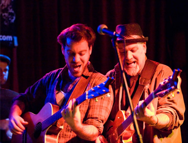 Lyle, left, and his father Phile performing.
