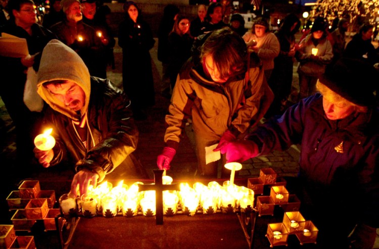 A 2002 vigil in Monument Square remembers the homeless, whose distress, a letter writer says, is a product of our greedy lifestyles.