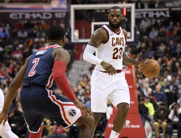 Wizards guard John Wall tries to defend Cleveland's LeBron James during the Cavs' 106-99 win Sunday in Washington. James finished with 20 points, 12 rebounds and 15 assists.