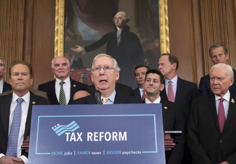 Sen. Majority Leader Mitch McConnell, center, joins with House Speaker Paul Ryan, behind McConnell to his immediate left, and other Republican lawmakers to talk about their plans for rewriting the federal tax code.