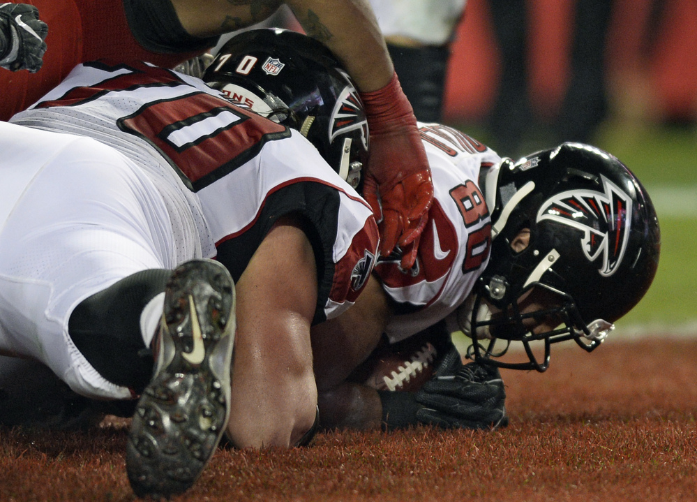 Falcons tight end Levine Toilolo falls on a fumble by running back Devonta Freeman for a touchdown Monday night against the Tampa Bay Buccaneers.