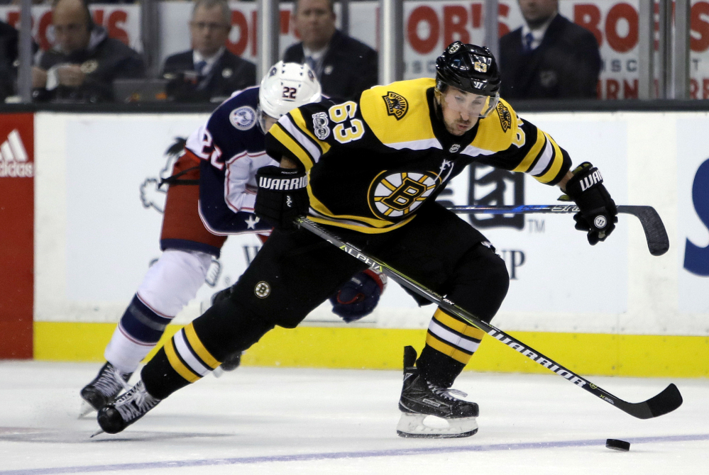 Bruins left wing Brad Marchand skates away from the Blue Jackets' left wing Sonny Milano in the second period.