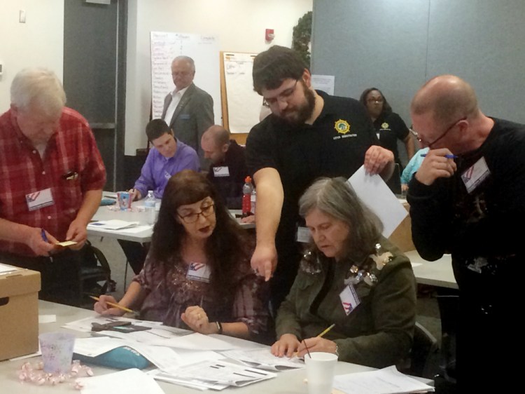 Election officials in Newport News, Va., examine ballots that a computer failed to scan during a recount for a House of Delegates race on Tuesday. Republican incumbent Del. As of today the race is tied.