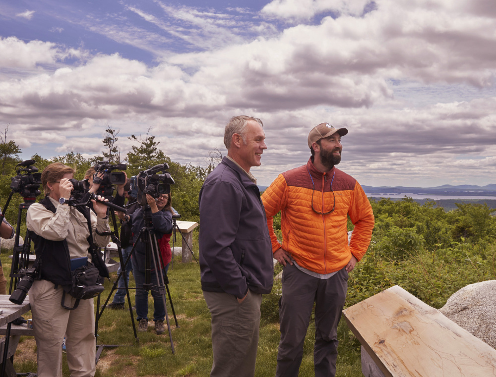 Interior Secretary Ryan Zinke, left, and Lucas St. Clair look out over the Katahdin Woods & Waters National Monument in June. 