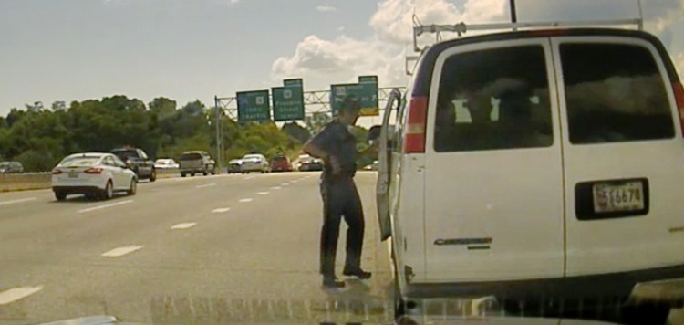 In a photo taken from Maine State Police Trooper Robert Burke III's video dash camera, he talks to the driver of a van on I-295 on Sept. 9. Though Burke said he'd pulled over the van for a cracked windshield, his attention quickly turned to the immigration status of those inside.