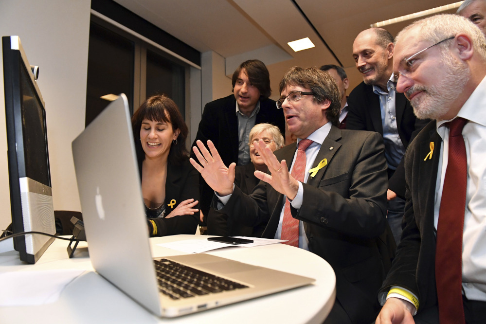 Ousted Catalan leader Carles Puigdemont watches election results for Spain's Catalonia region at the Square Meeting Center in Brussels, Belgium, on Thursday. Several members of the ousted Cabinet, including Puigdemont, have campaigned from Brussels, where they sought refuge from Spanish justice.