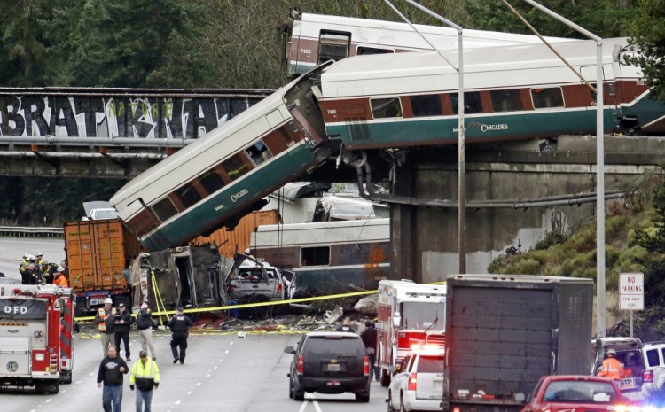 Cars from an Amtrak train lie spilled onto Interstate 5 alongside smashed vehicles in DuPont, Wash., on Monday. 