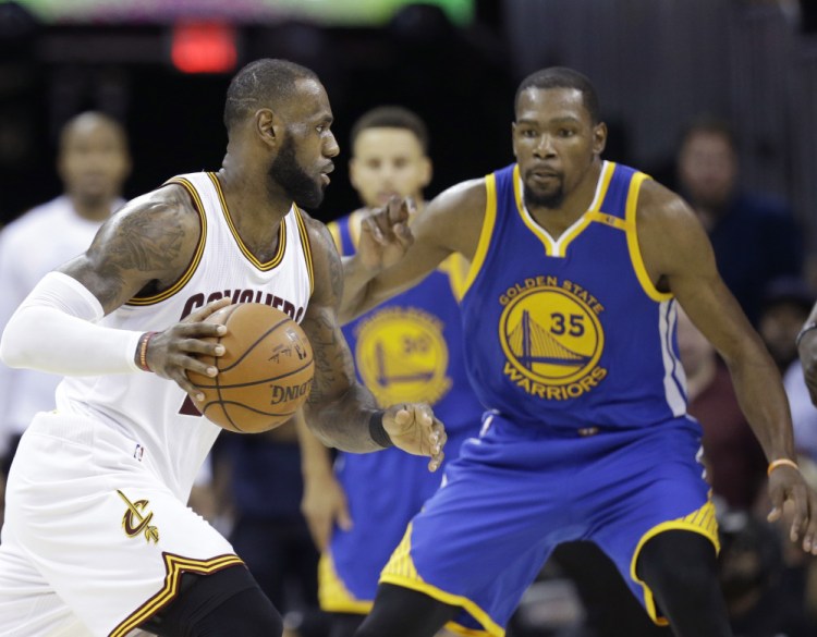 LeBron James, left, and Kevin Durant will be spending Christmas together again, still rivals, as the Cleveland Cavaliers visit the Golden State Warriors.