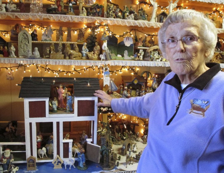 Shirley Squires, 87, of Guilford, Vt., shows off nativity scenes on display at her home. Many are crafted from wood, porcelain, plastic or clay.
